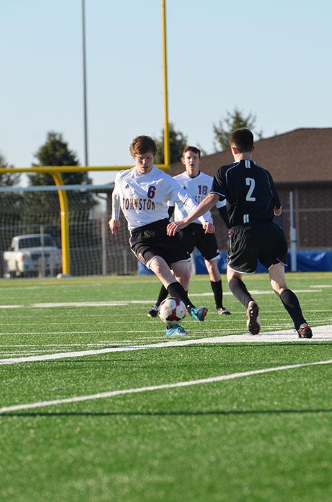 Playing in a junior varsity (JV) game, sophomore Noah Hanes tries to avoid the WDM Valley opposite. The boys' soccer program consisted of the varsity team and 3 JV teams.