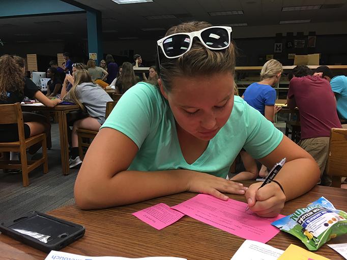 Senior Megan Schraeger fills out the request sheet to drop Advanced Speech. Students were able to come in and change their schedules Aug. 18.