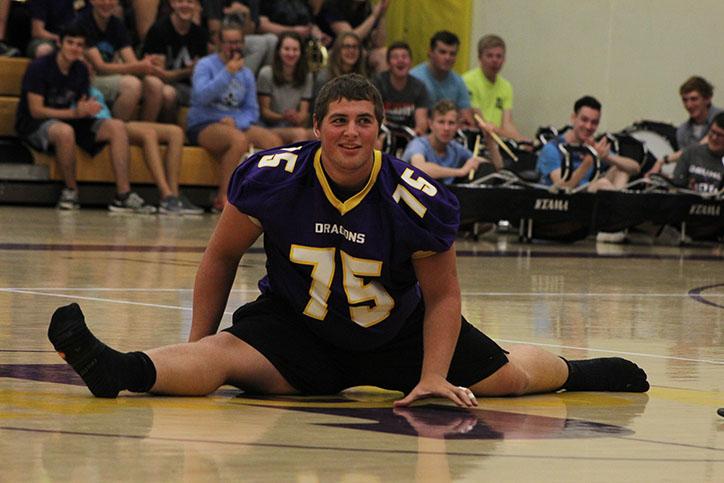 Senior Bryce Rowland performs his annual split during the pep assembly. Rowland has performed this stunt during the first pep assembly for two years.