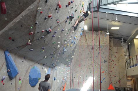 Reagan Lehmen 19 holds the rope for Carson Jendro 18 as he lead climbs. Both Lehmen and Jendro climb competitively.