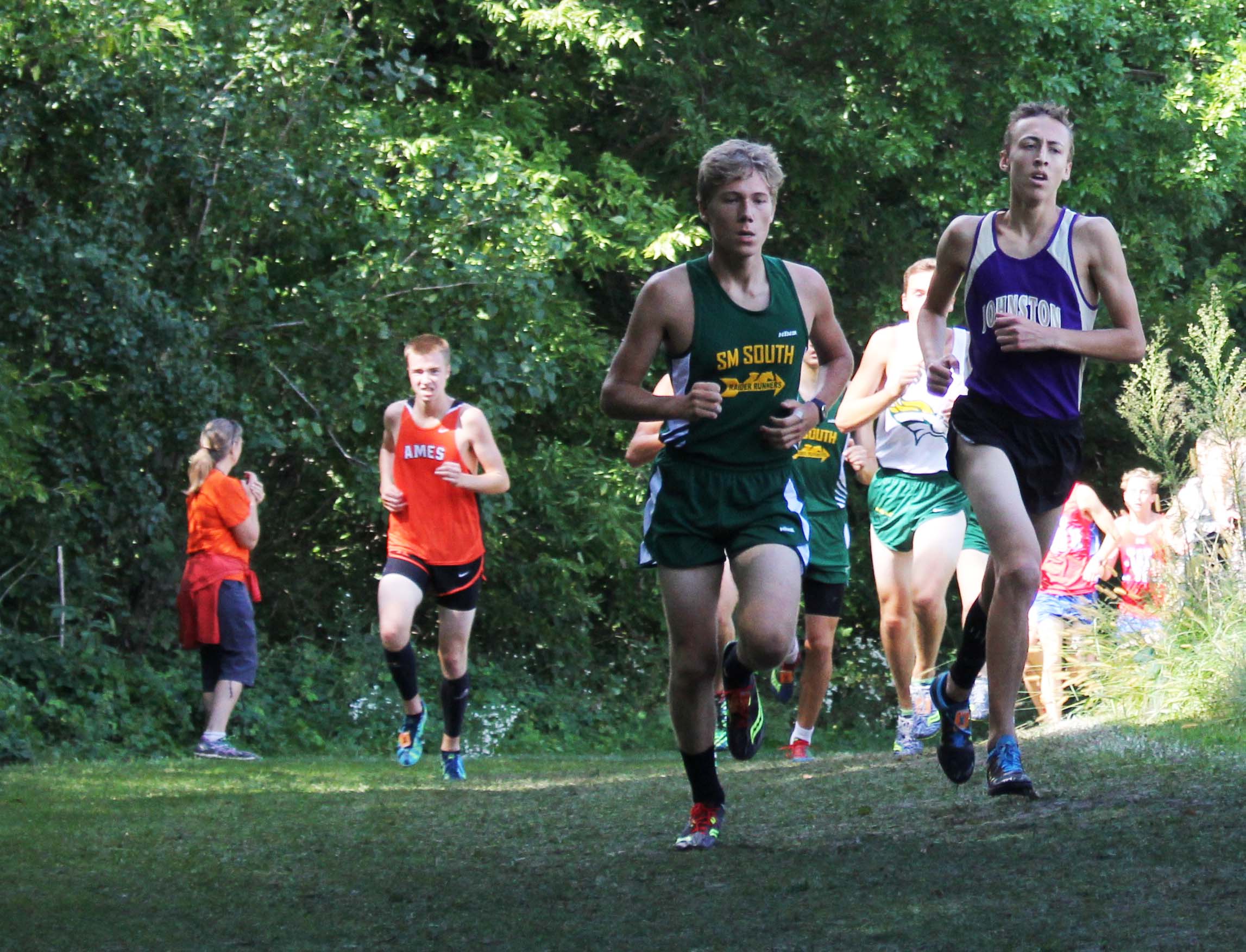 Riley Chartier 17 works to quicken his pace. Cross Country had a meet Oct. 13 at Marshalltown Community College.