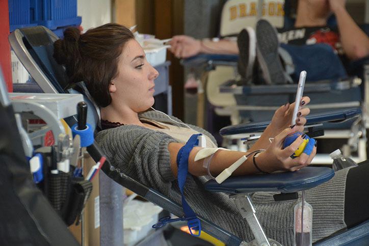 Haley+Toepfer+17+patiently+waits+for+her+donation+of+blood+to+end.+The+blood+drive+was+held+Oct.+27.