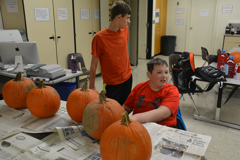 Juniors Jacob Anderson  and Jack Marren prepare to carve pumpkins. Art club sponsered the event Oct. 21.