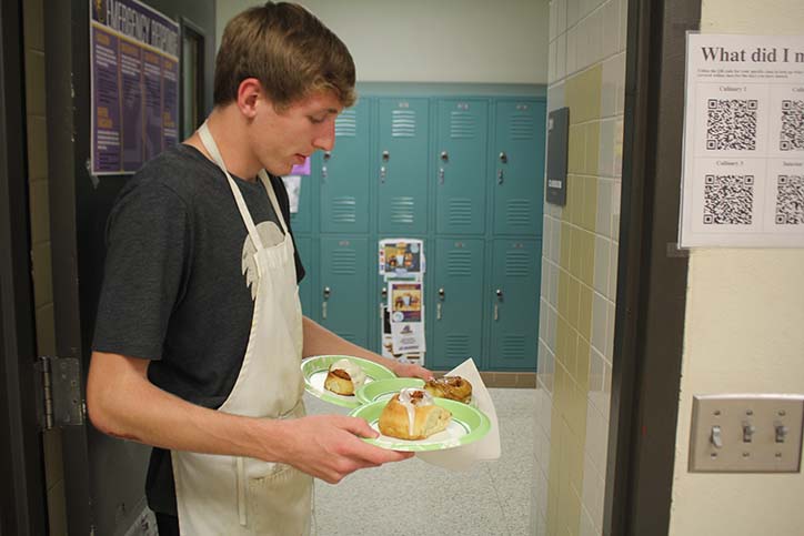 Jordan Goreth '17 takes hand-made cinnamon rolls to various teachers during cinnamon roll event in culinary class. 