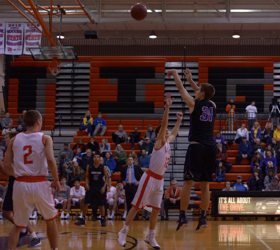Camden VanderZwaag'18 completes a shot over a defending Valley player. The boys play next Friday, Dec 9. at home.