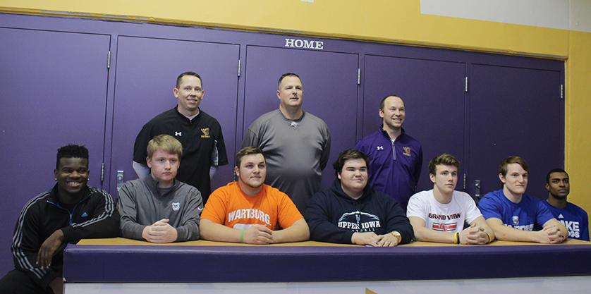 Students sit with their teammates and coaches during their signing ceremony.
Front row (left to right): Augustus Geneyan 17, Nick Lucas 17, Luke Grzech 17, Bryce Sturges 17, Gannon Svestka 17, Grant Gossling 17, and Jeran Proctor.
Back row (left to right): Coaches Tony Kruse, Brian Woodley, 
