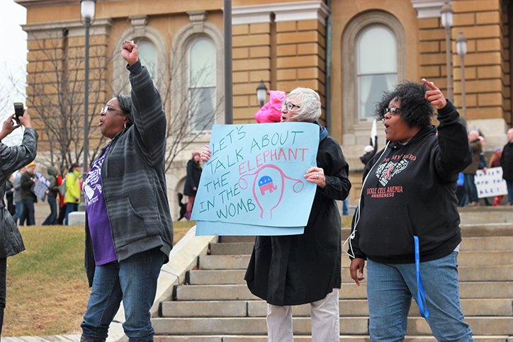 Three women chant at the Womens March at the Iowa capital building in Des Moines. The Womens March took place at locations across the country to advocate for womens rights.