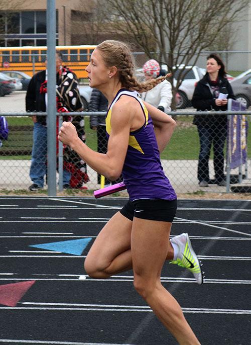 Josie Hovey 19 takes off as she receives the hand off in the 4 by 800m relay. The girls track team competed at home on March 28. 