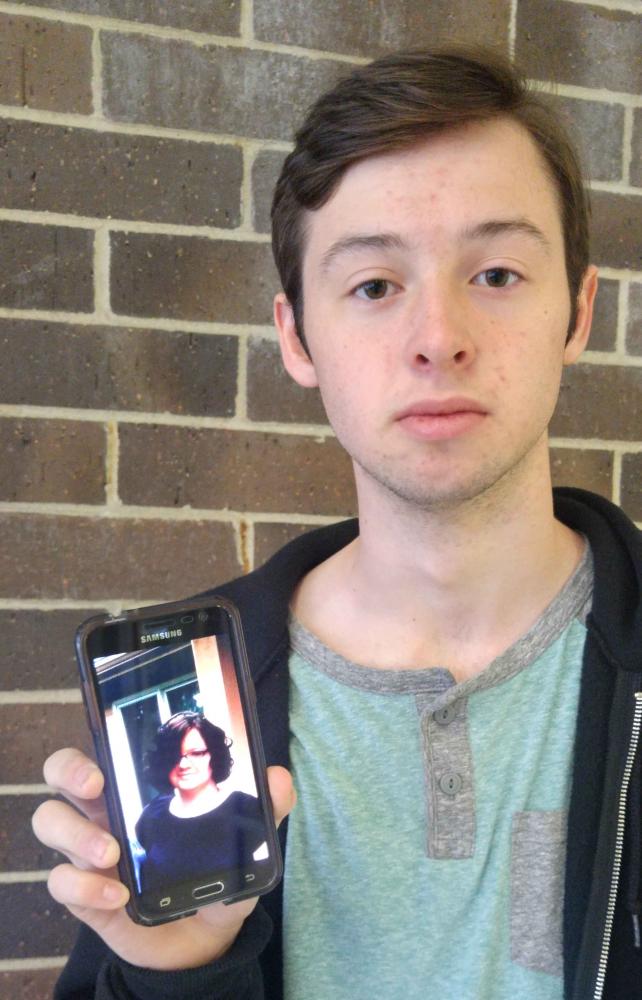 Collin Needham 18 is holding a picture of his elder sister. Even though Needham loves being around his sister, getting compared to her is a sore spot.
