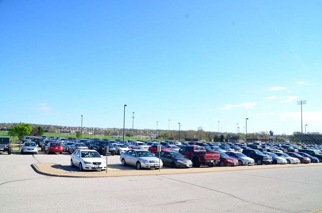 A shot of the parking lot during 3rd period. A number of students at Johnston High School park in the lot using fake parking passes. 