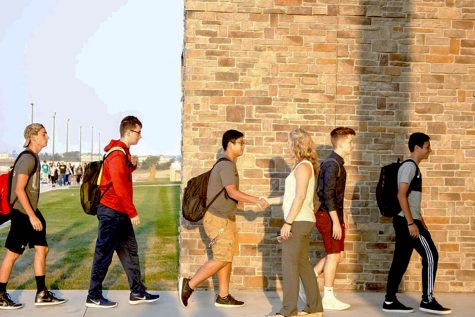 Students line up to shake hands with Lisa Boge before entering the school. Shaking hands is one of the most practiced policies from Capturing Kids' Hearts.