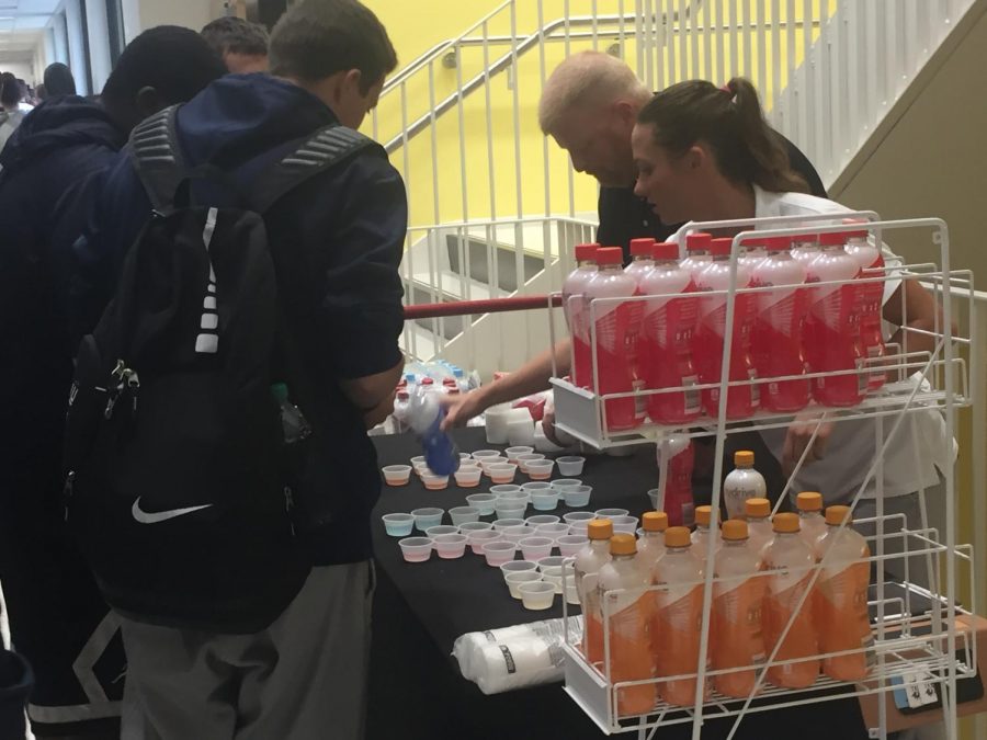 Students receive samples of Hydrive energy water.
