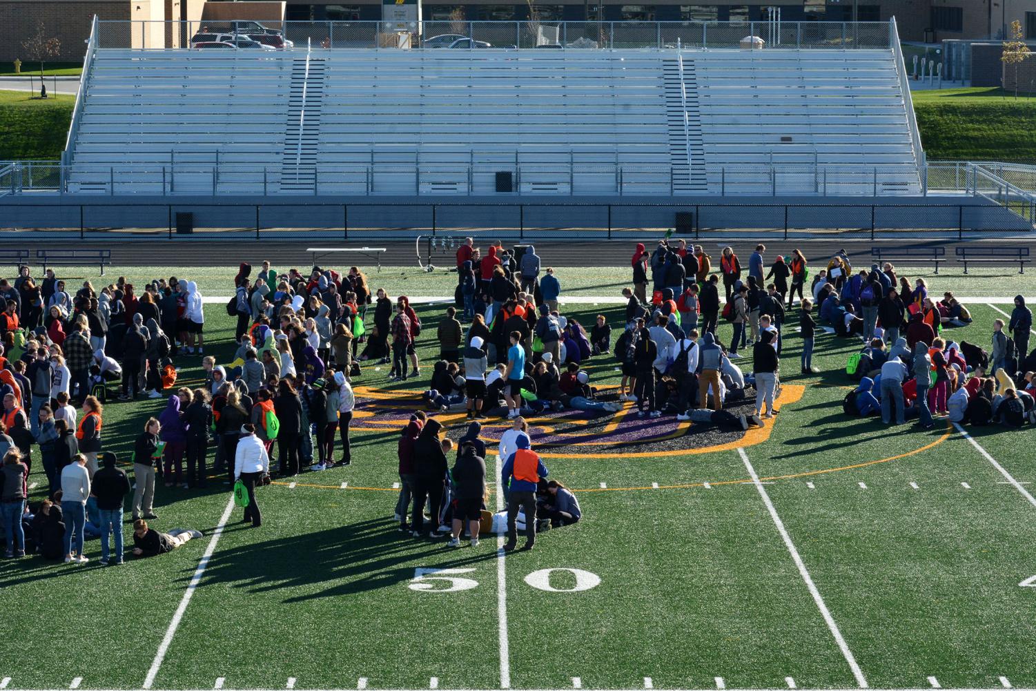 Students huddle during the fire drill. The drill was conducted during 40 degree weather with 25 miles-per-hour winds.