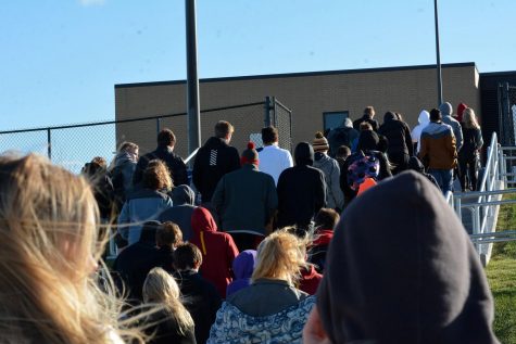 Students prepare to re-enter the building. Bottlenecks occurred during re-entry.