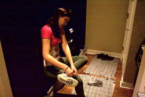 Katelyn Winkler '19 demonstrates how she had to tie her shoes with her brace on. The brace prevents her from bending over so she had to find a more efficient way.