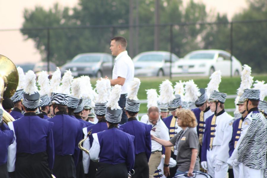 Jeffery Robilliard, Band Director, gives the varsity marching band a pep talk. Robilliard delivers one of these pep talks before every performance. 