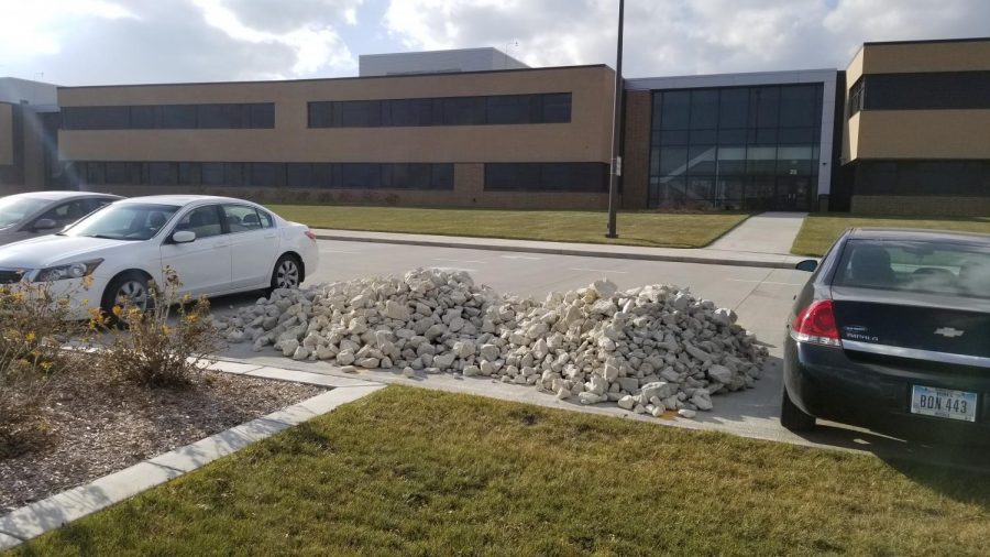 Two medium sized rock piles filled two student parking spaces.