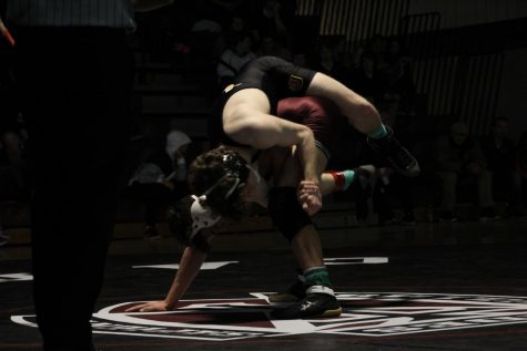 Johnston wrestling teams beat Dowling Maroons