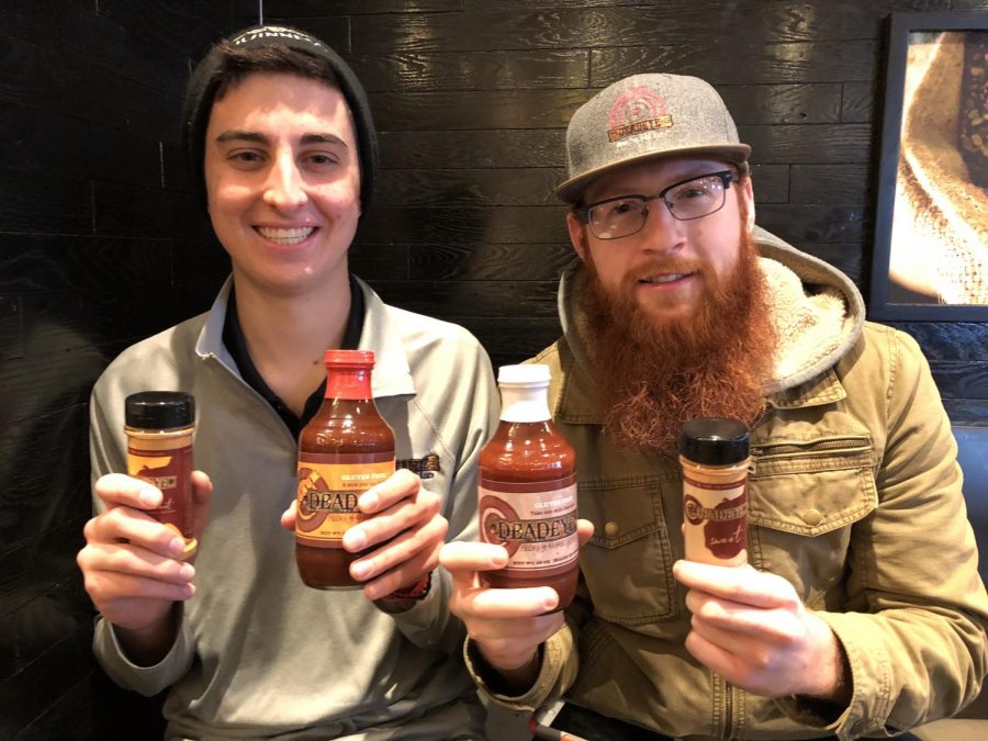 Hanstad and Devos show the Deadeye BBQ sauce. The business was founded by the two when they were freshmen.