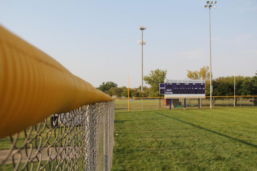 The chain-link fence extends around the outfield. Instead of having bumps and holes, the new turf outfield will be smooth and safe.