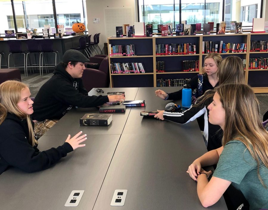 Colt Smallwood 19, Logan Mahon 20, Lilly Mahon 20, Jacque Heggen 21 and Addie May 20 discuss Stephen King books while eating sugar cookies. Octobers theme is spooky books.