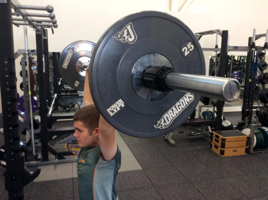 AJ Lass doing an over head press in the weight room. AJ has been weight lifting for over a year in order to get in shape for his enlistment to the National Guard.