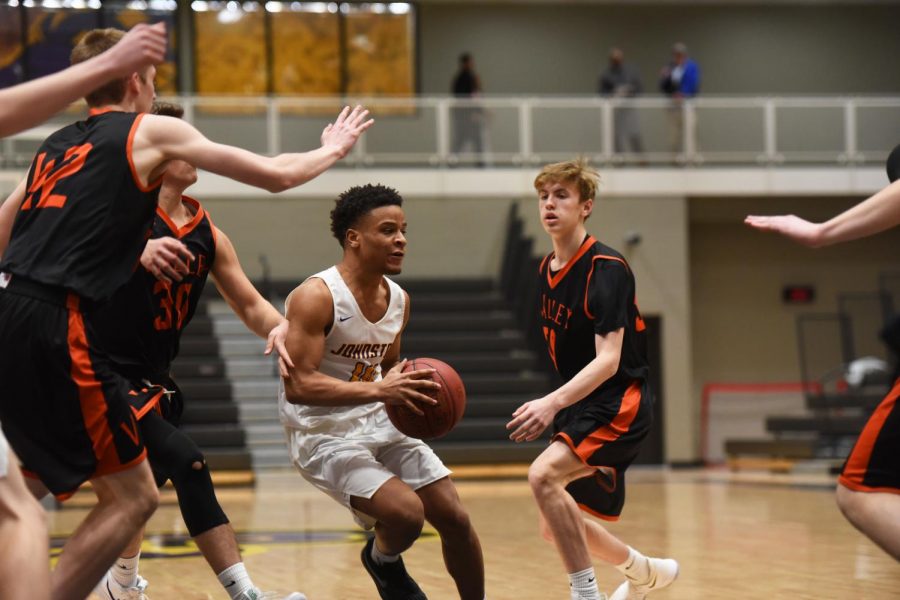 Ty Petty 19 looks to pass the ball while surrounded by four Valley players. Petty had one assist off the bench for the Dragons.