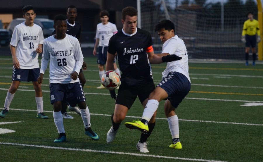 Erik Catus 19 challenges for the ball in a match against Des Moines Roosevelt Apr. 9. Catus had three shots in the 1-0 win.