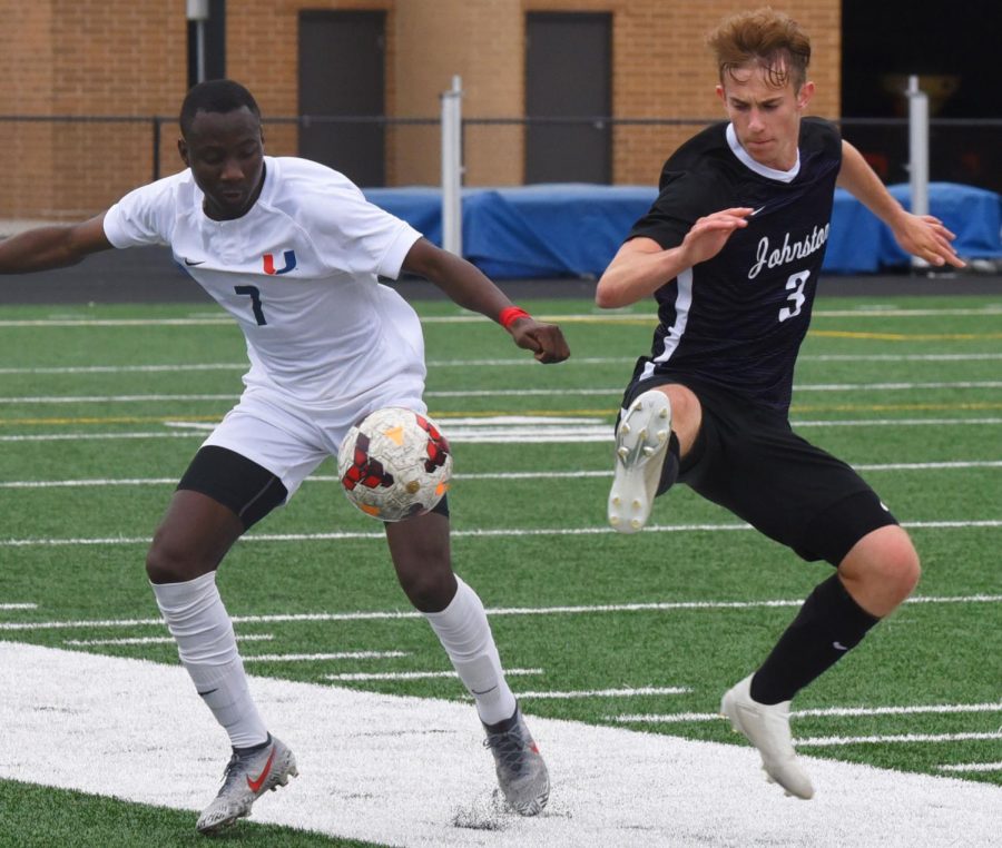 Cooper Peddicord 20 challenges an Urbandale player for the ball in a game on May 1. Peddicord and his team won the game 2-0.