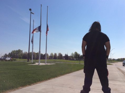 Shea Carnahan '19 looking at the flags as he leaves the high school