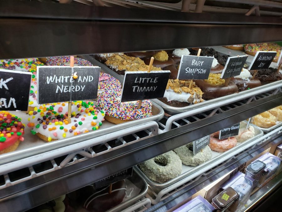 A selection of donuts presented in Hurts Donut.