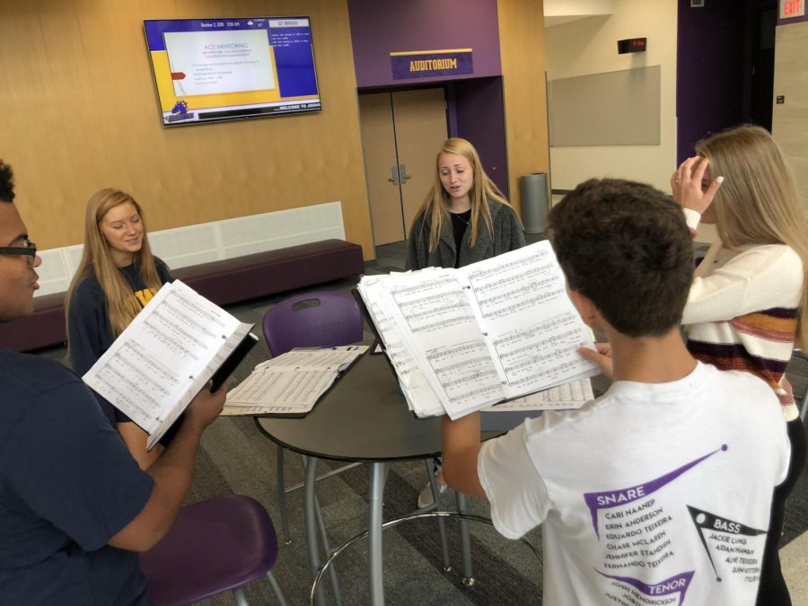 Choir Students practicing in the auditorium commons during Dragon Time. 