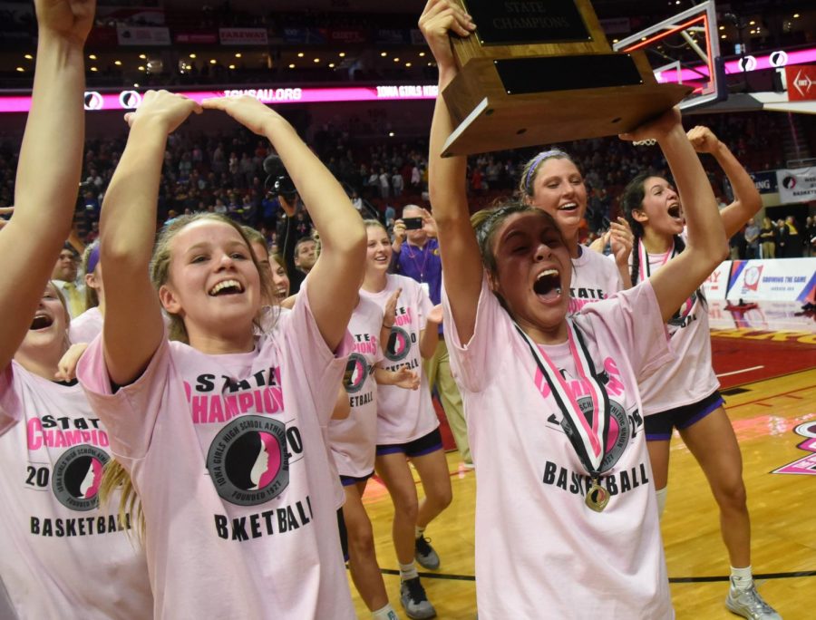 Maya McDermott 20 holds the state trophy high before the student section. Last year the girls made it to the state semi-finals where they then lost to West Des Moines Valley