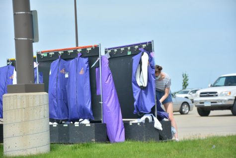 A show choir member finding their costume, in order to take it home.
