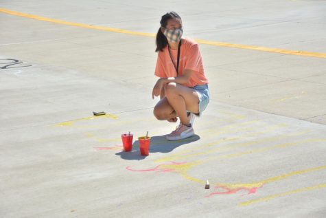 Kristen Tu '22 helping paint the student council stadium painting on Sept. 13 at the high school to kick off homecoming week.