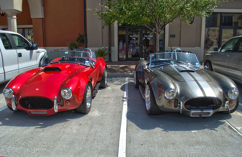 These two cars are Carroll Shelby Cobras. 