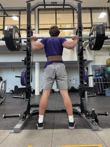 Johnston football recruit Jack Rutz 22 prepares to squat weight on Monday, March 8th.