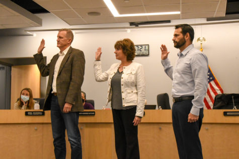 Three newly elected school board members, Clint Evans, Deb Davis and Derek Tidball, being sworn into their new positions.