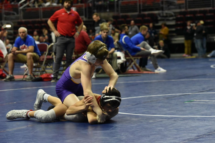Caden Leonard '25 pushing his opponent into the mat. Leonard won the match which enabled him to move on to the next round. 
