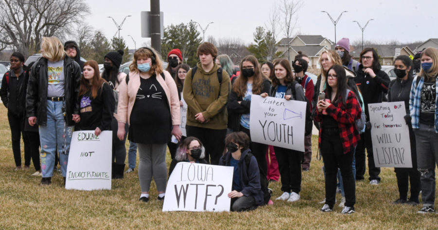 Students listen to speakers in front of the school after the walk out on Friday, April 15, 2022. 