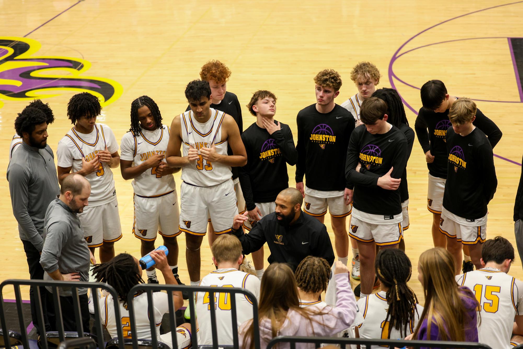 Johnston players huddled together during a timeout 