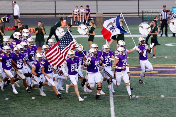 The Dragons rush out of the locker room before the season opener against the Waukee Warriors on August, 29th 2025.